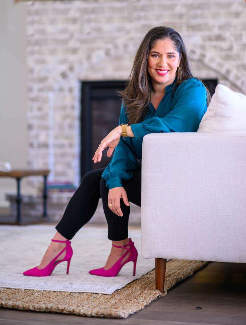 Tamara Garza on a modern couch in natural light